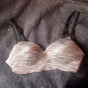 This is a white,black, and gray colored bra.